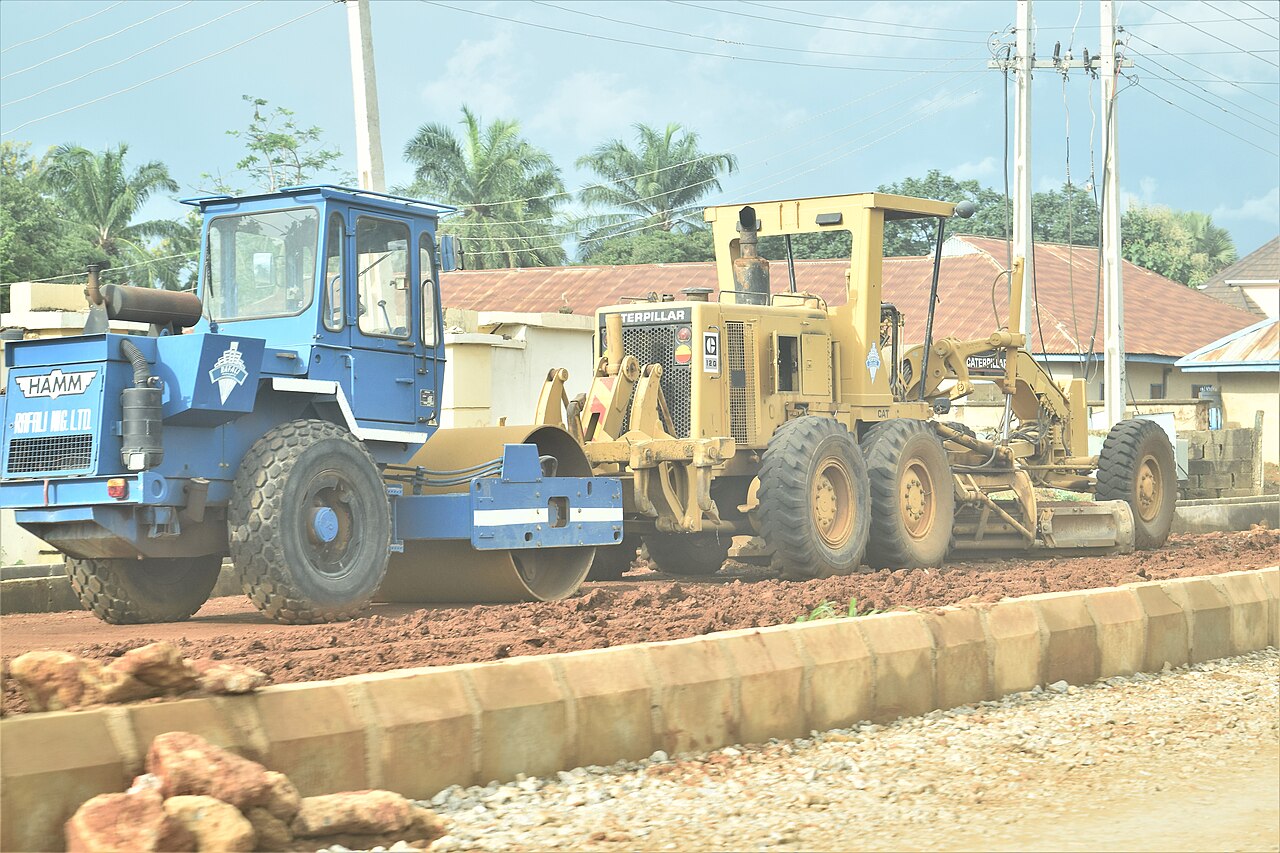 Excavator and grader working on a road construction site in Kafanchan, Nigeria